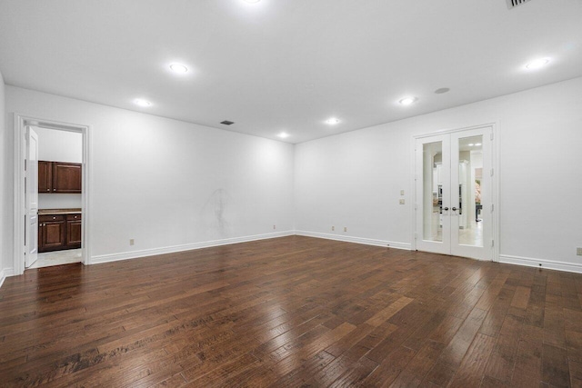 empty room featuring dark hardwood / wood-style floors and french doors