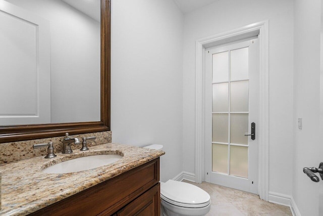 bathroom featuring tile patterned floors, toilet, and vanity