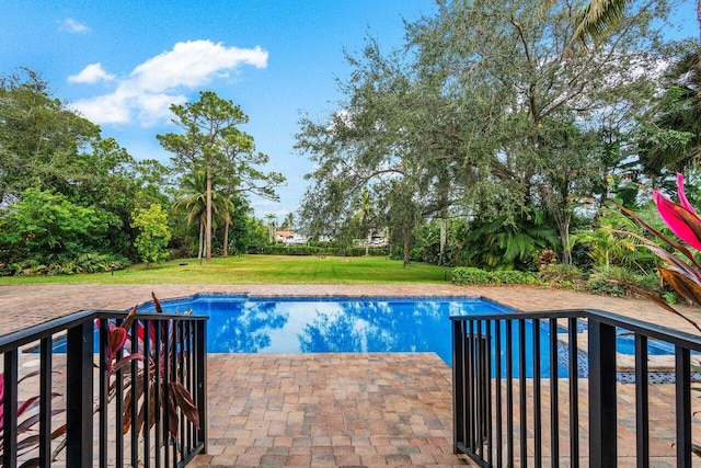 view of pool with a yard