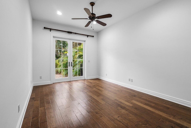 empty room with ceiling fan, french doors, and dark hardwood / wood-style floors