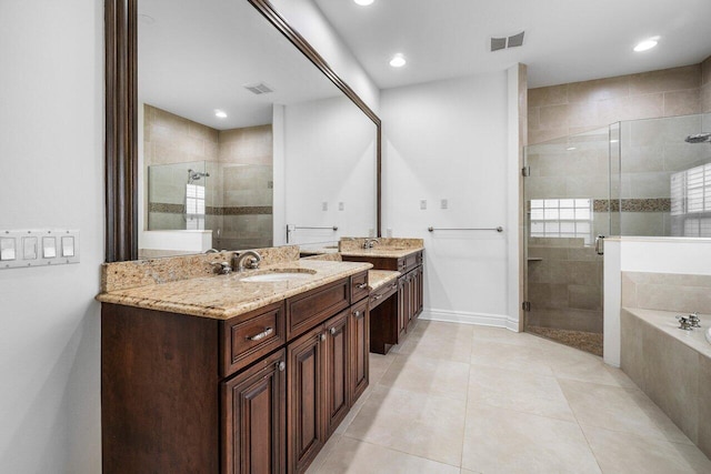 bathroom featuring vanity, independent shower and bath, and tile patterned flooring