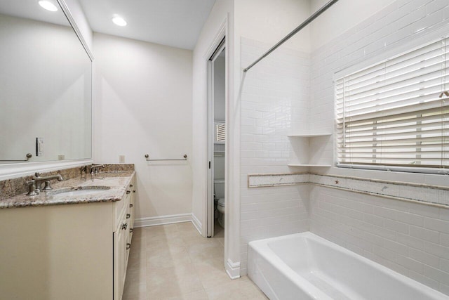 bathroom with toilet, tile patterned flooring, and vanity