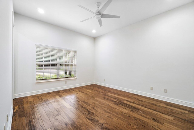 spare room with ceiling fan and dark wood-type flooring