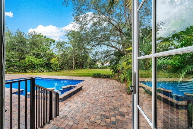 view of pool with a patio area and a lawn