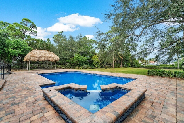 view of swimming pool with a gazebo, an in ground hot tub, a yard, and a patio