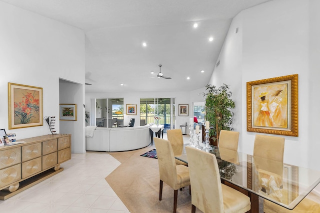 tiled dining area featuring ceiling fan and high vaulted ceiling