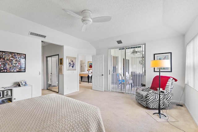 carpeted bedroom featuring ceiling fan, a textured ceiling, and a closet