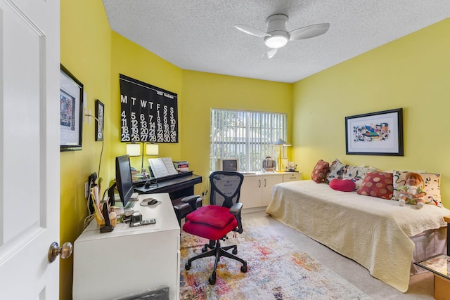 carpeted bedroom featuring ceiling fan and a textured ceiling