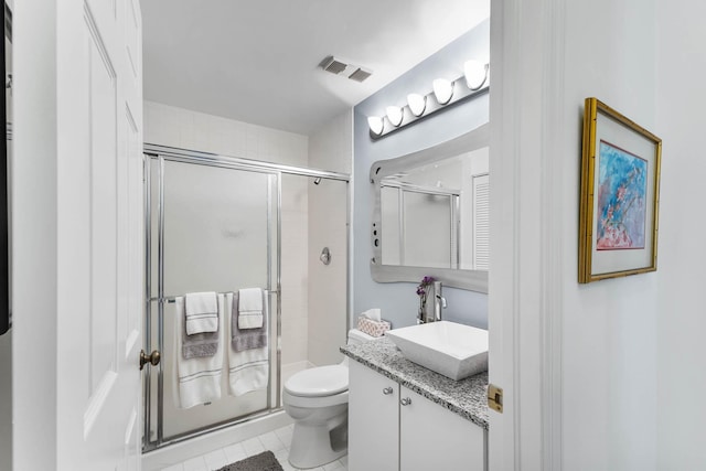 bathroom featuring walk in shower, vanity, and toilet