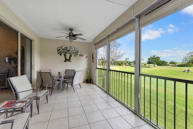 sunroom / solarium featuring ceiling fan