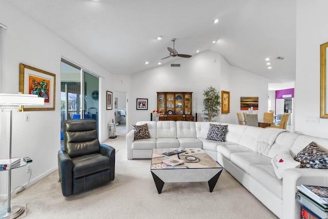 carpeted living room with ceiling fan and vaulted ceiling