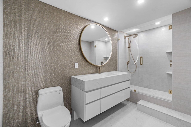 bathroom with vanity, an enclosed shower, tile walls, and toilet