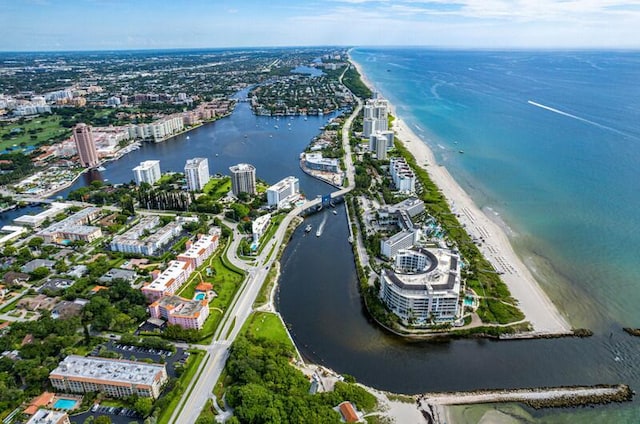 drone / aerial view with a water view and a beach view