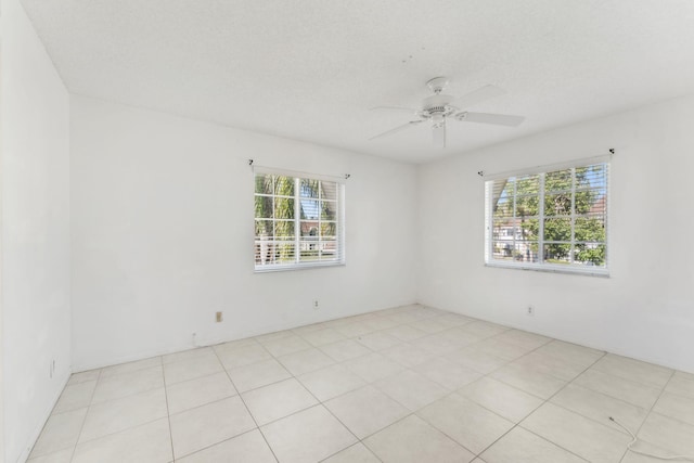 empty room featuring a textured ceiling and ceiling fan