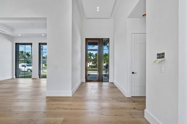 entryway with light wood-style flooring and baseboards