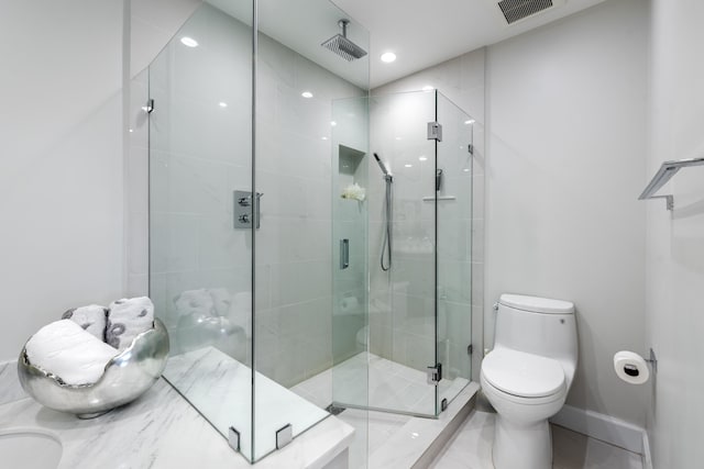 bathroom with toilet and an enclosed shower