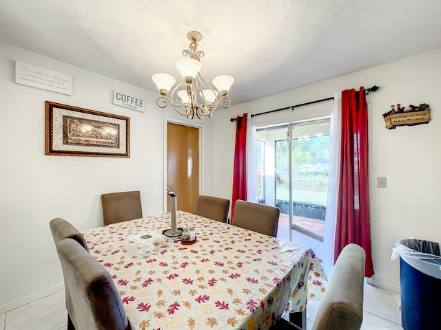 dining space with a notable chandelier, light tile patterned flooring, and a textured ceiling