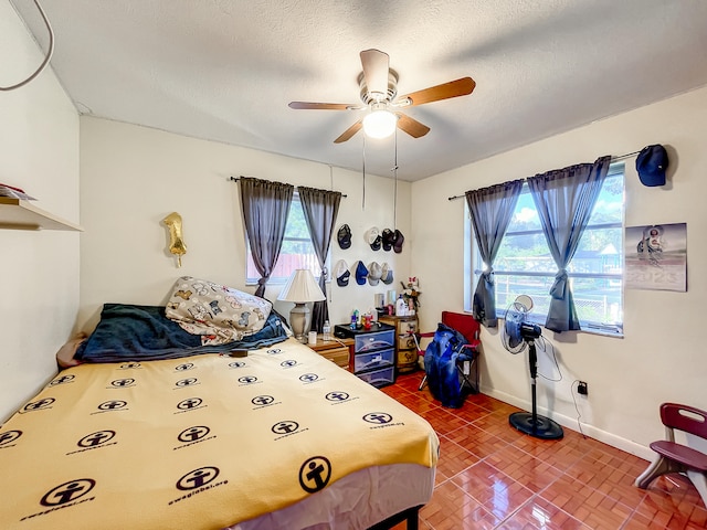 bedroom with a textured ceiling and ceiling fan