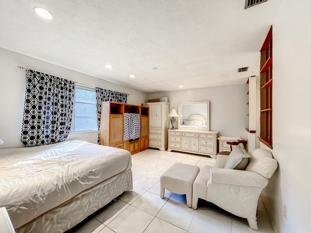 tiled bedroom with a textured ceiling