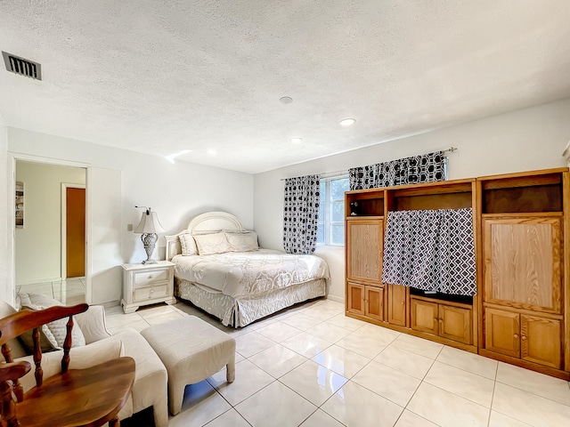 tiled bedroom with a textured ceiling