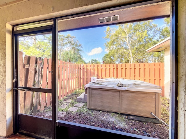 exterior space featuring a hot tub