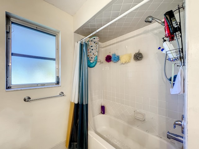 bathroom with shower / bath combo with shower curtain