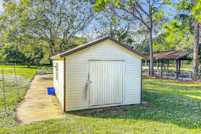 view of outbuilding featuring a yard