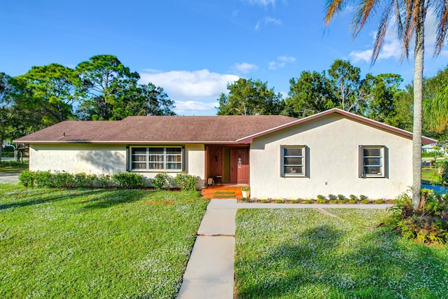 ranch-style house featuring a front lawn