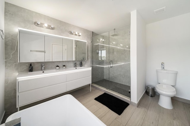 bathroom featuring vanity, toilet, an enclosed shower, and wood-type flooring