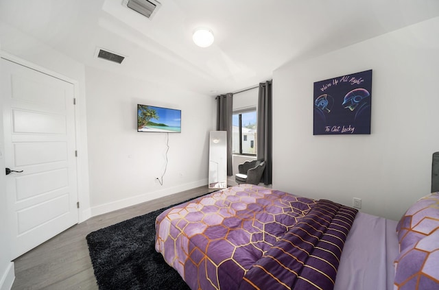 bedroom with hardwood / wood-style flooring