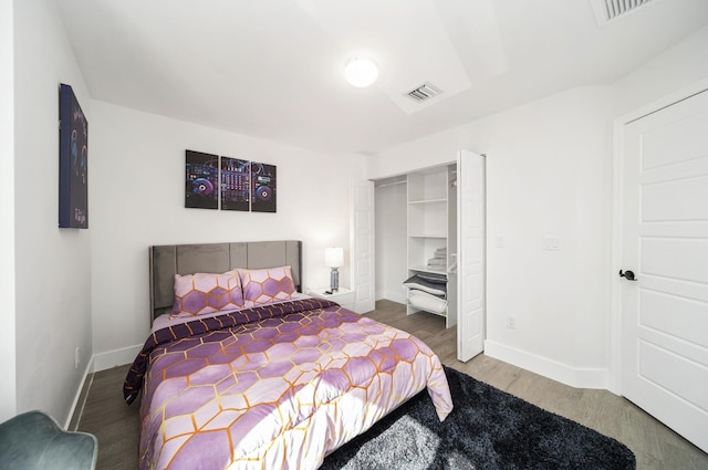 bedroom with hardwood / wood-style floors and a closet