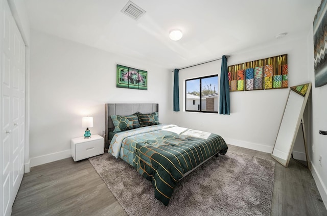 bedroom featuring hardwood / wood-style floors and a closet