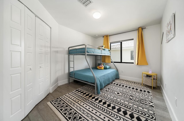 bedroom with a closet and hardwood / wood-style flooring