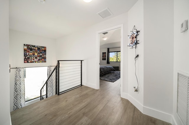 hallway with light hardwood / wood-style flooring