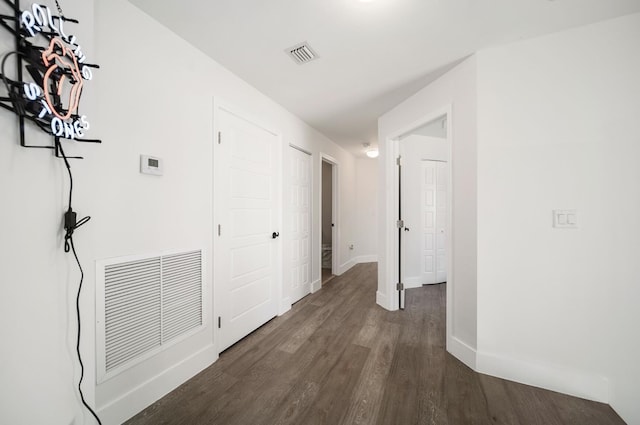 hallway with dark hardwood / wood-style flooring