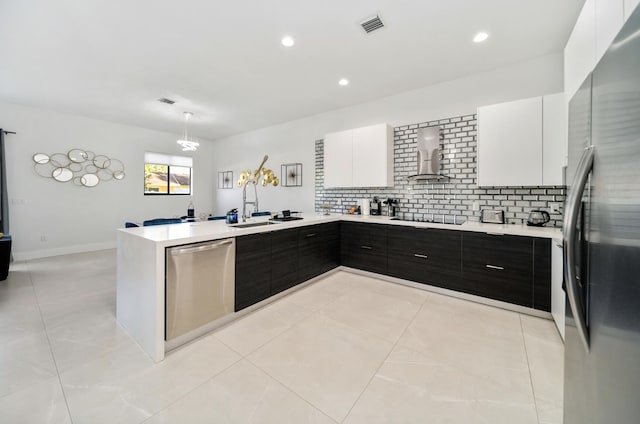 kitchen featuring white cabinetry, sink, decorative backsplash, dark brown cabinets, and appliances with stainless steel finishes