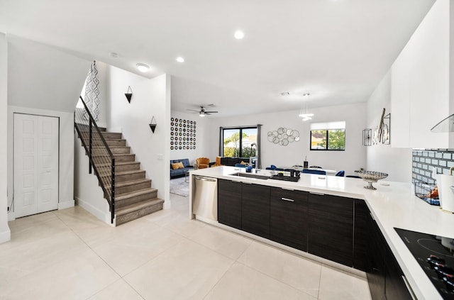 kitchen featuring stainless steel dishwasher, dark brown cabinets, black electric cooktop, ceiling fan, and light tile patterned floors