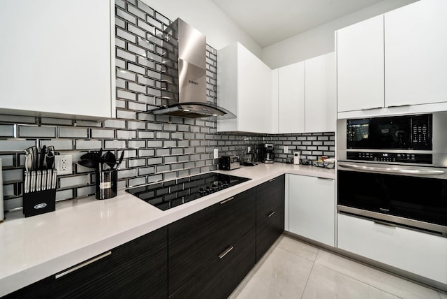 kitchen featuring backsplash, white cabinets, black electric stovetop, and wall chimney exhaust hood