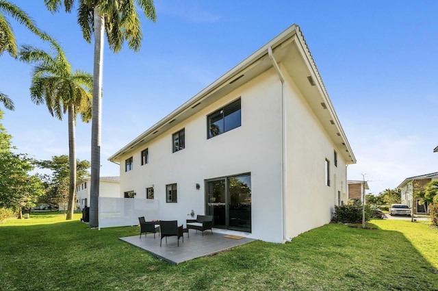 back of house featuring a yard and a patio