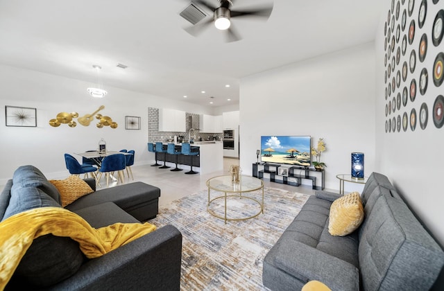 living room featuring light tile patterned floors and ceiling fan