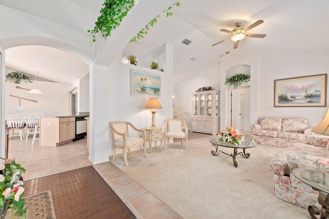 living room with light carpet, vaulted ceiling, and ceiling fan