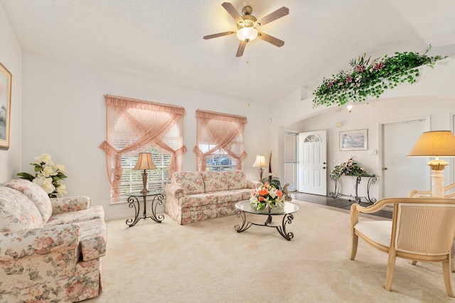 living room featuring carpet flooring, ceiling fan, a textured ceiling, and vaulted ceiling