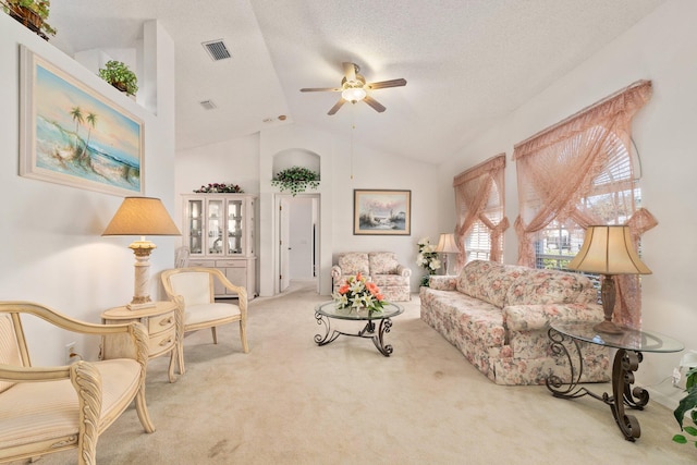 carpeted living room with a textured ceiling, ceiling fan, and lofted ceiling