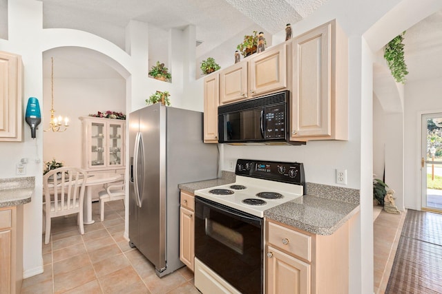 kitchen featuring white electric range oven, a textured ceiling, pendant lighting, light tile patterned floors, and a notable chandelier