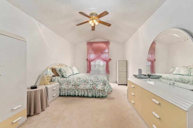 carpeted bedroom with ceiling fan and lofted ceiling