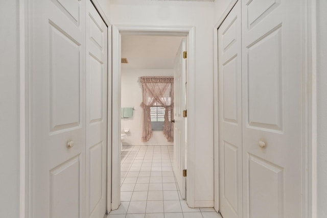 corridor with light tile patterned floors