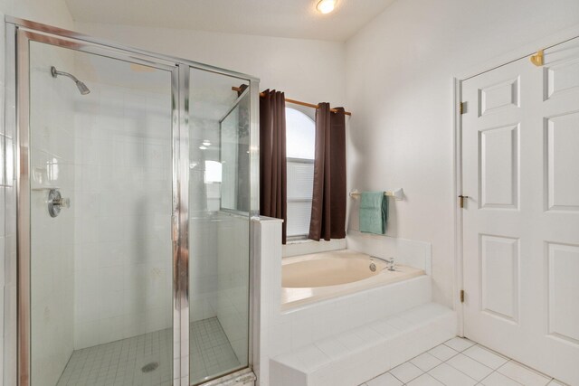 bathroom featuring separate shower and tub, tile patterned flooring, and vaulted ceiling