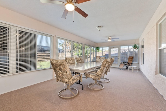 sunroom featuring ceiling fan