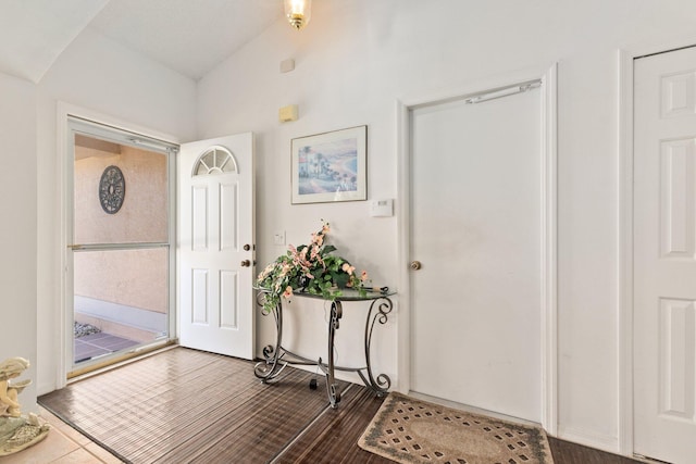 foyer entrance featuring dark hardwood / wood-style floors and lofted ceiling