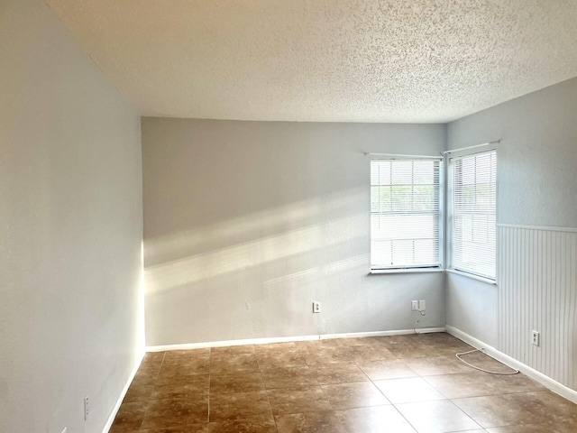 spare room featuring a textured ceiling